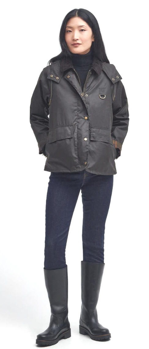 Model wearing olive Barbour Avon waxed jacket with front pockets and gold hardware